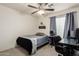 Bedroom featuring a desk, ceiling fan, closet, and a view of the backyard at 16350 N Desert Sage St, Surprise, AZ 85378