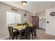 Bright dining area with table and chairs, located adjacent to laundry and kitchen at 16350 N Desert Sage St, Surprise, AZ 85378