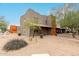 Two-story home boasts desert landscaping with a covered porch and neutral color scheme at 16350 N Desert Sage St, Surprise, AZ 85378