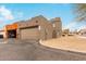 View of building with a garage and desert landscaping, showcasing its architectural style and curb appeal at 16350 N Desert Sage St, Surprise, AZ 85378