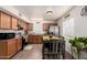 Eat-in kitchen with stainless steel appliances, wood cabinets, and a casual dining table at 16350 N Desert Sage St, Surprise, AZ 85378