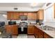 Cozy kitchen features wood cabinetry, stainless steel appliances and laminate countertops at 16350 N Desert Sage St, Surprise, AZ 85378