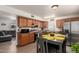 Charming kitchen featuring stainless steel appliances, adjacent dining area, and wood-look flooring at 16350 N Desert Sage St, Surprise, AZ 85378