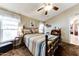 Serene bedroom featuring a comfortable bed, a ceiling fan, natural light, and a small desk area at 17200 W Bell Rd # 1590, Surprise, AZ 85374