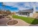 Beautiful backyard featuring lush grass and desert landscaping with an enclosed patio at 1767 W Kiowa Ave, Mesa, AZ 85202