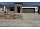 Charming single-story home with stone accents, neutral paint, manicured landscaping, and a two-car garage at 17780 W Onyx Ave, Waddell, AZ 85355