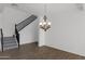 Bright living room featuring tile floors and a staircase with decorative tile accents at 18053 W Rimrock St, Surprise, AZ 85388