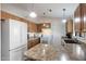 Functional kitchen with oak cabinets, island counter, white appliances, and ample counter space for meal preparation at 1835 Leisure World --, Mesa, AZ 85206