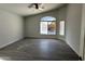 Bright, spacious room with a large window overlooking a pool and waterfall feature at 18626 N 28Th Way, Phoenix, AZ 85050