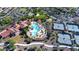 Aerial view of a community pool with tennis courts, lush landscaping, and ample parking in a desirable neighborhood at 19839 N 267Th Ave, Buckeye, AZ 85396