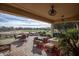 Covered back patio with ample seating area, views of the golf course, and stylish outdoor furniture at 19839 N 267Th Ave, Buckeye, AZ 85396