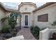 Inviting front entrance featuring a beautiful landscaped walkway, desert plants and a decorative security door at 19839 N 267Th Ave, Buckeye, AZ 85396