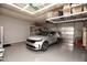 Clean garage featuring overhead storage racks and epoxy flooring at 19839 N 267Th Ave, Buckeye, AZ 85396