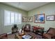 Bright living room showcasing neutral walls, plantation shutters and tasteful artwork at 19839 N 267Th Ave, Buckeye, AZ 85396