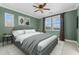 A furnished bedroom features a comfortable bed, ceiling fan, and natural light at 20821 W Ridge Rd, Buckeye, AZ 85396