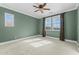 A vacant bedroom features a ceiling fan and natural light from two windows at 20821 W Ridge Rd, Buckeye, AZ 85396