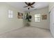 A bedroom with a ceiling fan, neutral walls, and ample natural light at 20821 W Ridge Rd, Buckeye, AZ 85396
