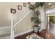 Grand entryway featuring a staircase, wood floors with marble inlay, and an elegant plant display at 20821 W Ridge Rd, Buckeye, AZ 85396