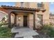 Inviting front porch with seating area, stone accents, and a tiled roof over the entry at 20821 W Ridge Rd, Buckeye, AZ 85396