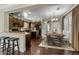 An open kitchen and dining area with granite counters, stainless steel appliances, and a wood dining table at 20821 W Ridge Rd, Buckeye, AZ 85396