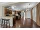 Open-concept kitchen and dining area featuring dark wood cabinets, granite countertops, and hardwood floors at 20821 W Ridge Rd, Buckeye, AZ 85396