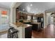 An open kitchen boasts granite countertops, dark cabinets, stainless steel appliances, and a center island at 20821 W Ridge Rd, Buckeye, AZ 85396