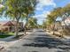 Quaint street view showcasing well-manicured lawns and mature shade trees at 20821 W Ridge Rd, Buckeye, AZ 85396