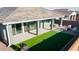 Spacious backyard with a covered patio, artificial grass, a hot tub, and outdoor seating, perfect for relaxation at 23282 S 229Th Pl, Queen Creek, AZ 85142