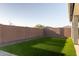 Spacious backyard featuring artificial turf and a block wall fence, perfect for privacy and low maintenance at 23282 S 229Th Pl, Queen Creek, AZ 85142