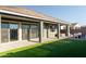 Relaxing backyard with a covered patio, artificial grass, a hot tub, and an outdoor seating area for entertaining at 23282 S 229Th Pl, Queen Creek, AZ 85142