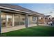 Private outdoor living space with artificial grass and covered patio for relaxation at 23282 S 229Th Pl, Queen Creek, AZ 85142