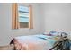 Bright bedroom with natural light, a window, and beach themed bedspread at 23282 S 229Th Pl, Queen Creek, AZ 85142