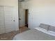 Bright, neutral bedroom with a cozy bed, closet and an open doorway at 23282 S 229Th Pl, Queen Creek, AZ 85142