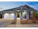 Charming home exterior with stylish architectural details, manicured landscaping, and an attached garage at 23282 S 229Th Pl, Queen Creek, AZ 85142