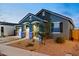 Home exterior with an inviting front entrance and tastefully landscaped yard, creating curb appeal at 23282 S 229Th Pl, Queen Creek, AZ 85142