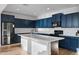 Modern kitchen featuring blue cabinets, stainless steel appliances and a kitchen island at 23282 S 229Th Pl, Queen Creek, AZ 85142