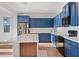 Modern kitchen featuring blue cabinets, stainless steel appliances, a kitchen island and plenty of counter space at 23282 S 229Th Pl, Queen Creek, AZ 85142