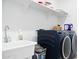 Laundry room with a washing machine, dryer, sink, and shelving for ample storage space at 23282 S 229Th Pl, Queen Creek, AZ 85142