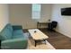 Cozy home office with a comfortable teal sofa and desk creating a productive workspace at 23282 S 229Th Pl, Queen Creek, AZ 85142