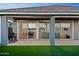 Covered patio showing seamless indoor-outdoor living with sliding glass doors and artificial grass at 23282 S 229Th Pl, Queen Creek, AZ 85142