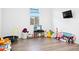 Bright and colorful playroom with hardwood floors, a TV, and an assortment of toys at 23282 S 229Th Pl, Queen Creek, AZ 85142