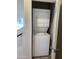 Laundry closet with stacked washer and dryer and doorway to a hallway at 2450 W Glenrosa Ave # 41, Phoenix, AZ 85015