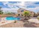 Expansive backyard features a sparkling pool and landscaped seating areas at 2528 W Mericrest Way, San Tan Valley, AZ 85144