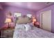 Comfortable bedroom featuring a decorative bed frame, purple walls and bedside tables at 2528 W Mericrest Way, San Tan Valley, AZ 85144