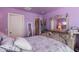 Bedroom featuring a decorative bed frame, mirrored dresser and purple walls at 2528 W Mericrest Way, San Tan Valley, AZ 85144