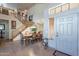 Elegant dining area with staircase, tile flooring, and abundant natural light at 2528 W Mericrest Way, San Tan Valley, AZ 85144