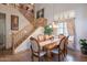 Charming dining room featuring stylish chairs, a modern chandelier, and staircase at 2528 W Mericrest Way, San Tan Valley, AZ 85144