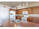 Bright kitchen with large island and bar seating, microwave, refrigerator, and ample cabinet space at 2528 W Mericrest Way, San Tan Valley, AZ 85144