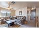 Cozy living room features a ceiling fan, plush seating, and a modern coffee table at 2528 W Mericrest Way, San Tan Valley, AZ 85144