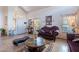 Comfortable living room with vaulted ceilings, stylish furniture, and tile flooring at 2528 W Mericrest Way, San Tan Valley, AZ 85144